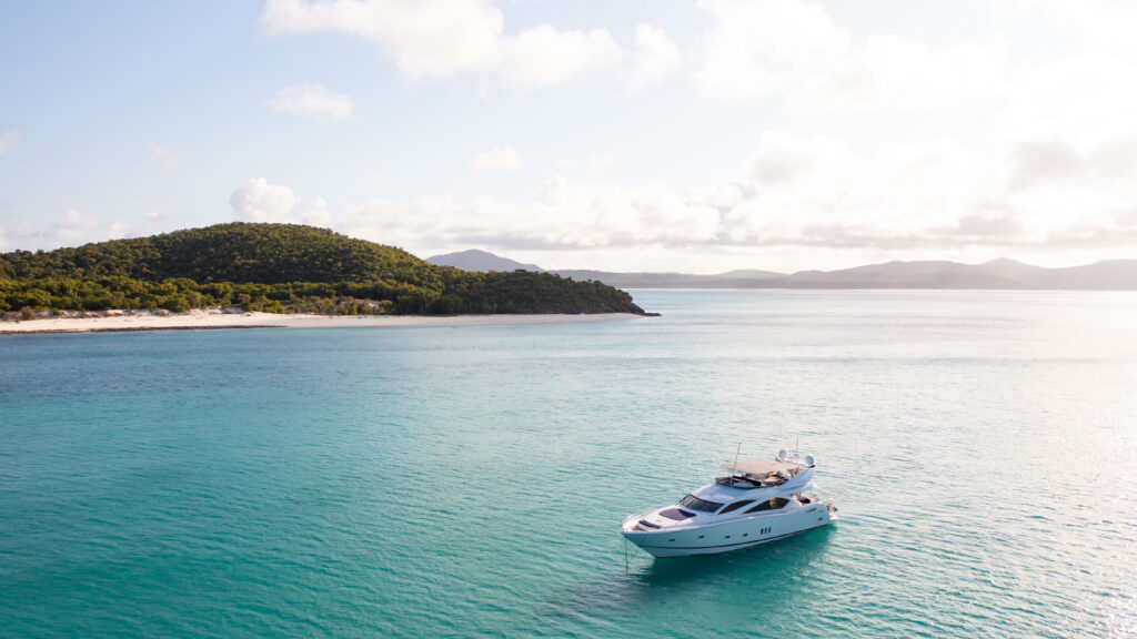 M/Y ALANI at anchor off a white-sand beach in the Whitsundays