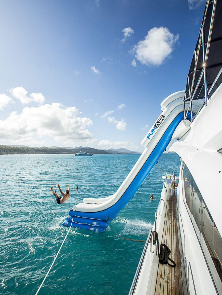 Guest on the FUNAIR waterslide from the top deck of M/Y ALANI