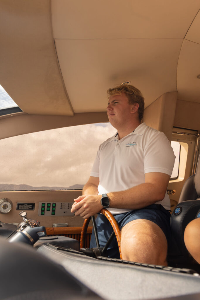 Captain George at the helm of M/Y ALANI